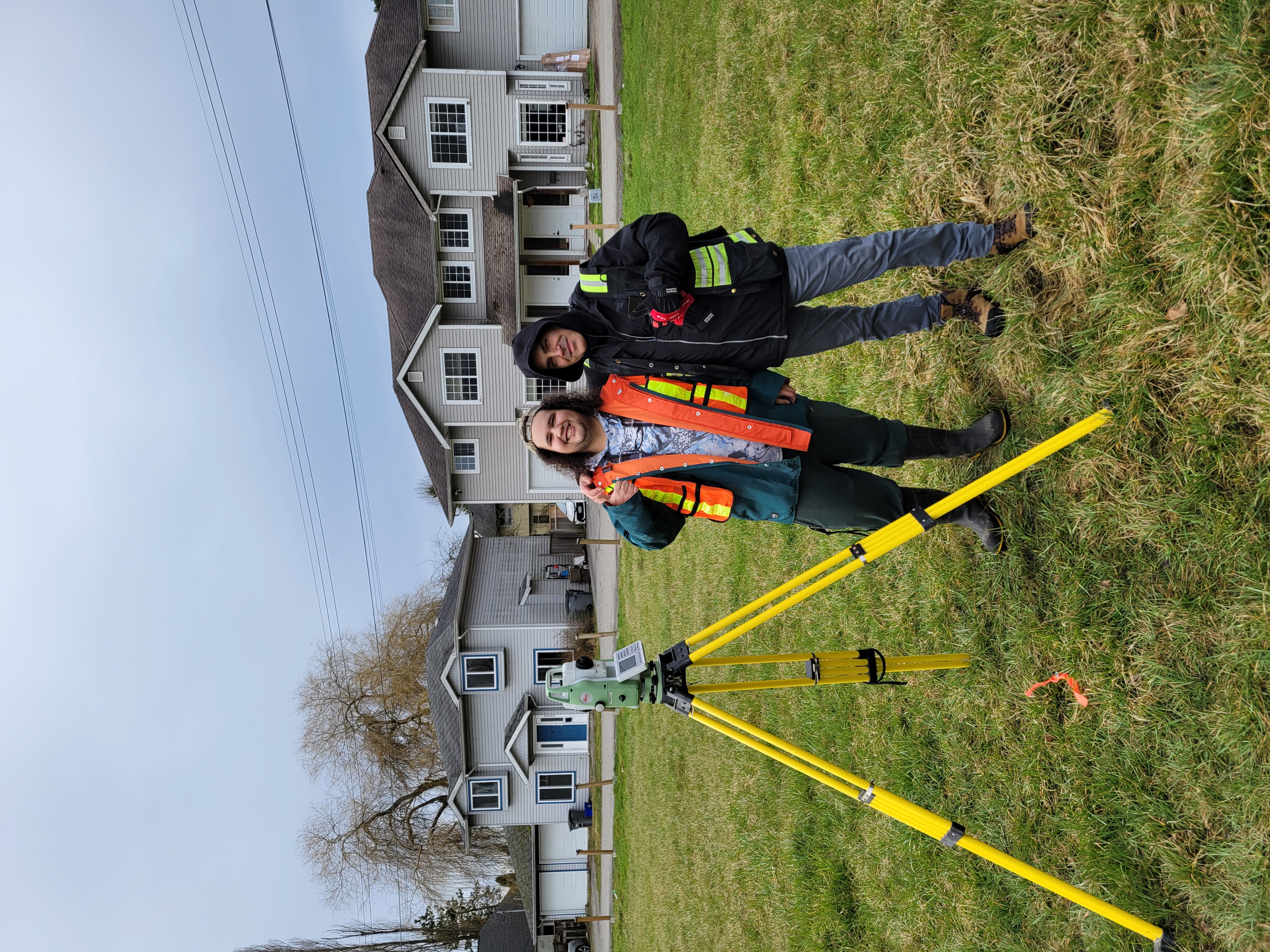 Deux personnes avec du matériel d'arpentage à Musqueam.